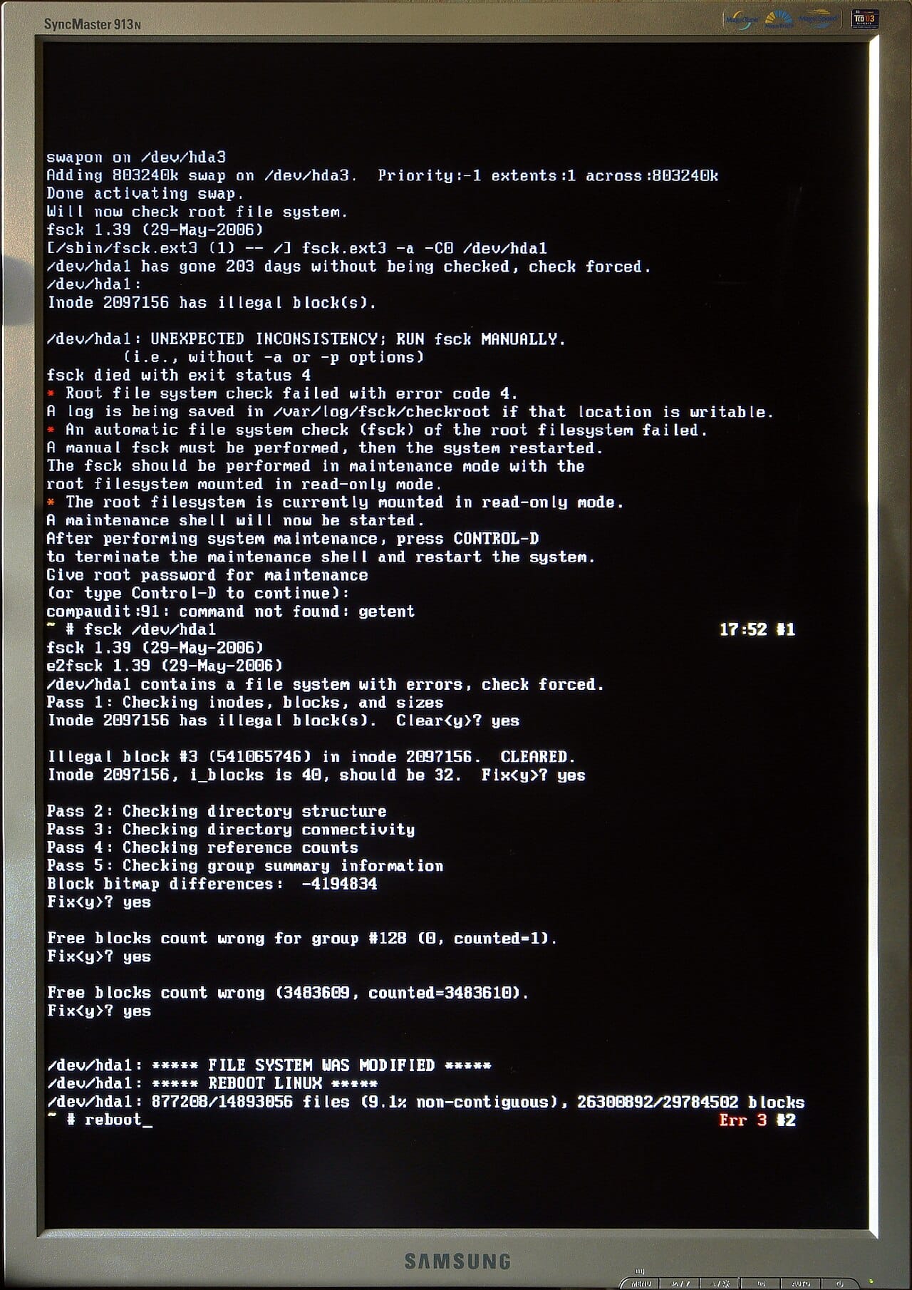 A monitor showing fsck output from 2006: an unexpected inconsistency on /dev/hda1, then passes 1 to 5 checking inodes, directories, connectivity, reference counts and group summaries, with fixes to the block bitmap and free block counts