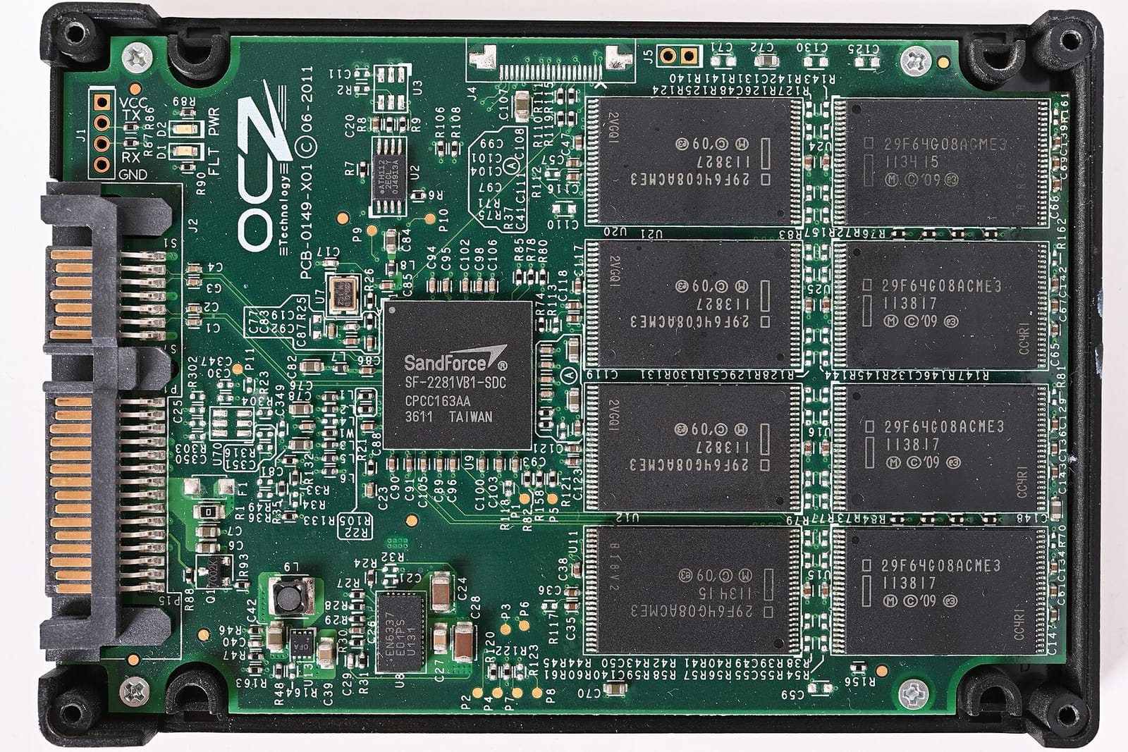 The circuit board of an OCZ Agility 3 SSD: a SATA connector on the left, a square SandForce controller chip in the middle, and eight black flash memory packages in two columns on the right