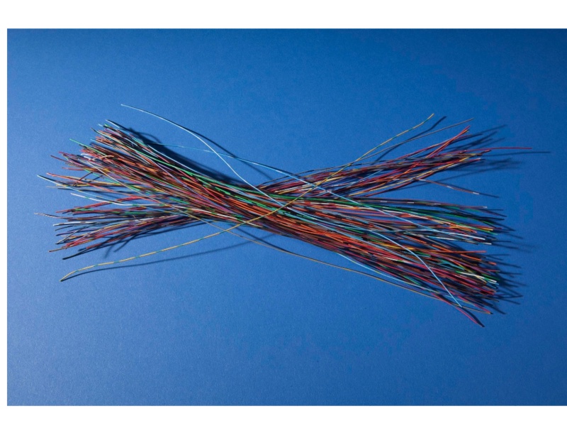 A bundle of short coloured wires, each about 30 centimetres long, laid out on a blue background