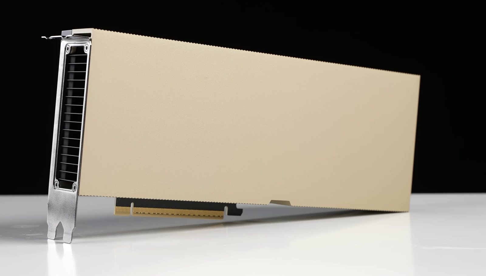 An NVIDIA H100 PCIe card, a long gold-coloured card with a metal bracket at one end and gold edge-connector fingers along its bottom edge