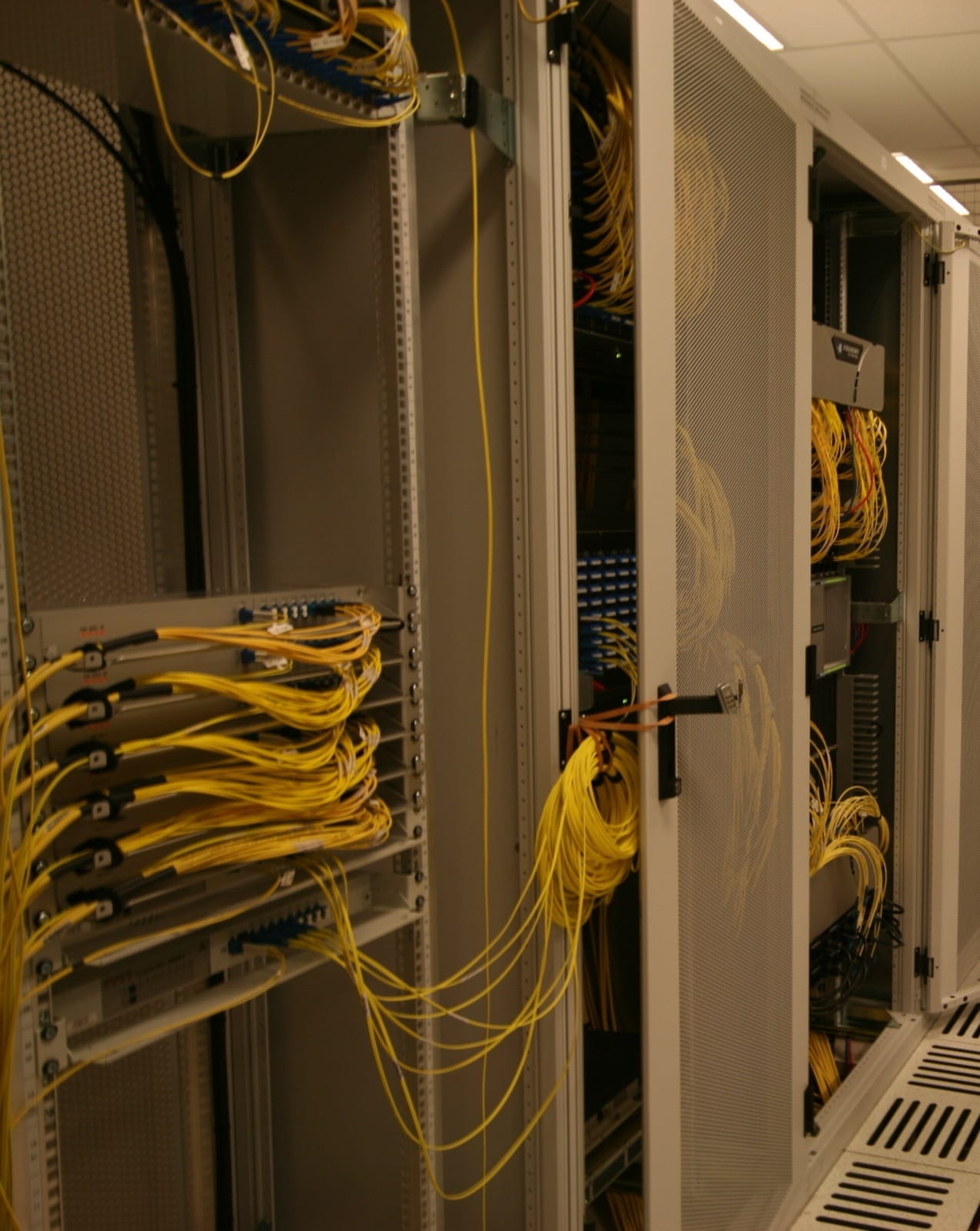 Network switches and fibre cabling in a cage at an internet exchange point