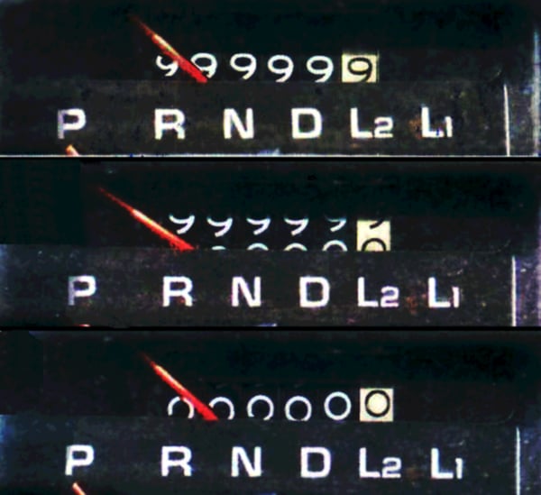 A car odometer showing all zeroes after rolling over from 99,999.9 miles