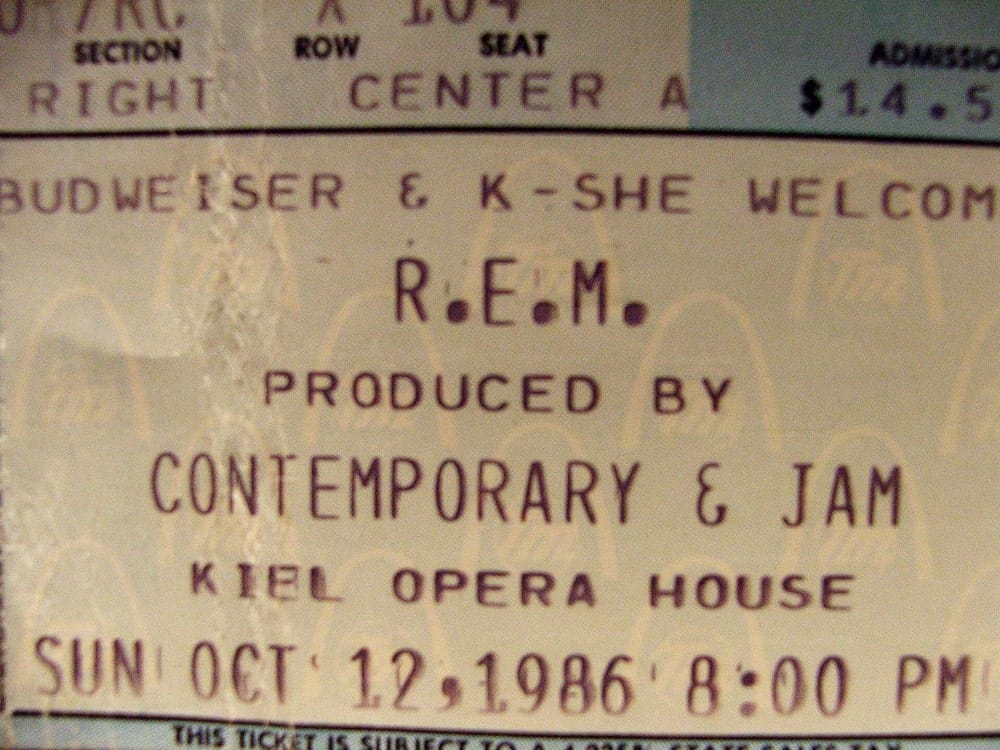 A faded paper concert ticket for R.E.M. at the Kiel Opera House on 12 October 1986, with printed fields for section, row and seat
