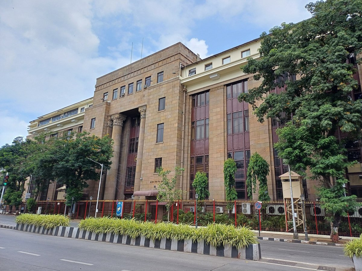 The stone front of the Reserve Bank of India building in Mumbai behind a red railing