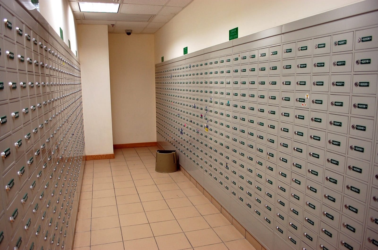 A corridor lined floor to ceiling with numbered post office boxes