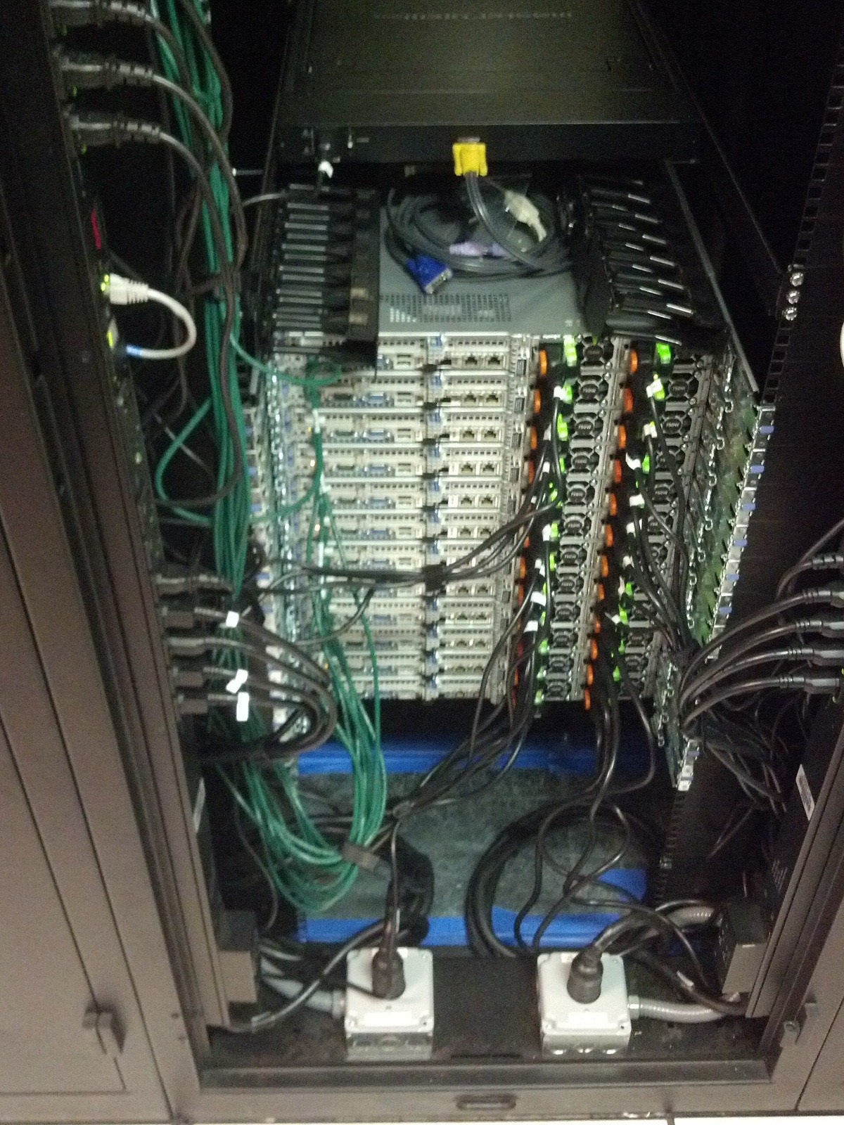 An open server rack with network cables being connected, in a data centre
