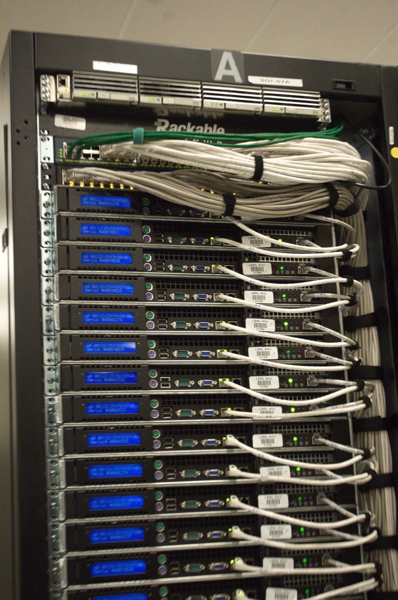 The back of a server rack: a stack of servers, each with network cables running to a switch at the top